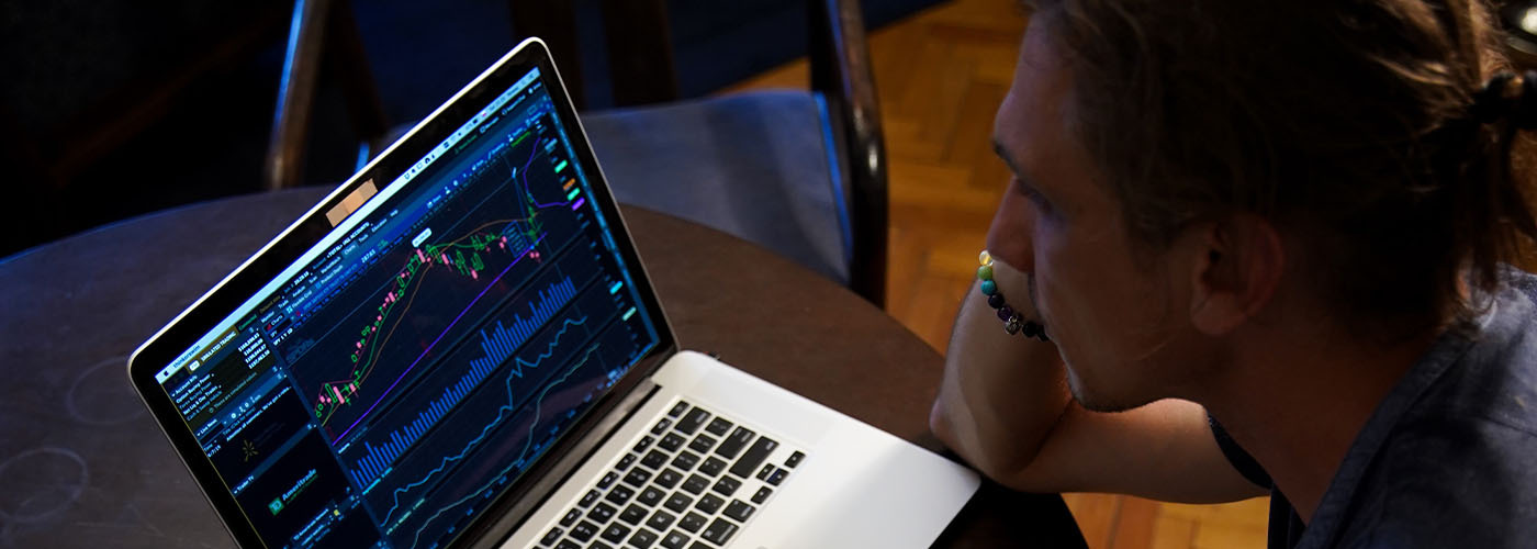 young male professional analyzing data on a laptop